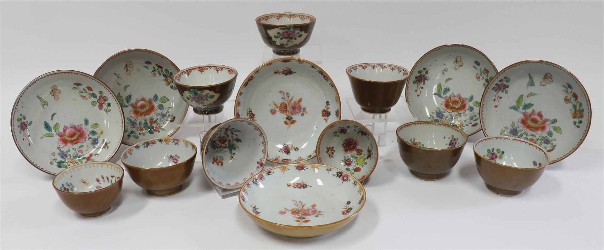 A series of porcelain famille rose cups and saucers on capucine ground, China, Qianlong, 18th