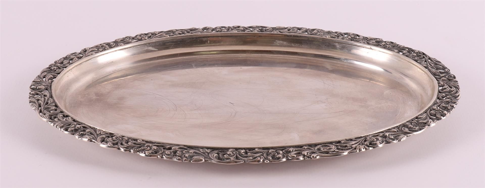 An oval second grade 835/1000 silver platter with floral openwork edge, year letter 1947, 254 grams,