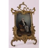 A brass photo frame in Louis XV style, France around 1900, h 19 cm.