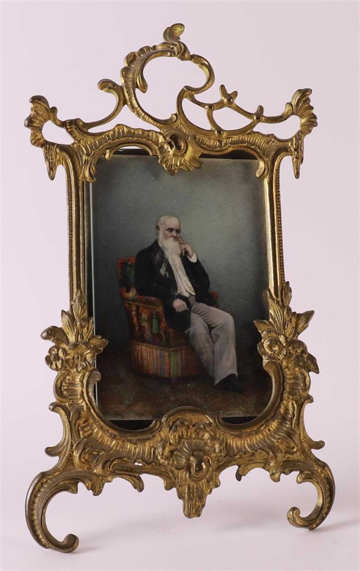 A brass photo frame in Louis XV style, France around 1900, h 19 cm.