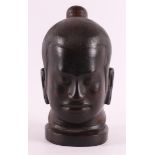 A carved wooden head of Buddha, 20th century, h 22 cm.