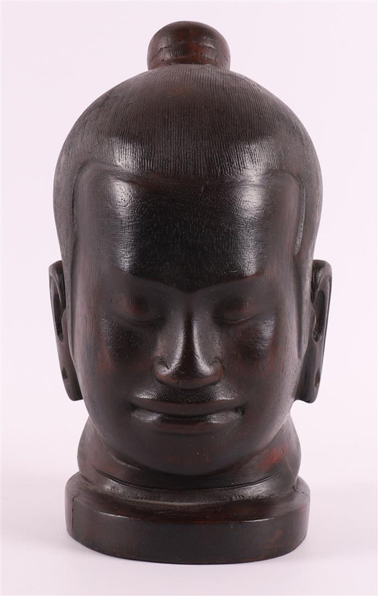 A carved wooden head of Buddha, 20th century, h 22 cm.