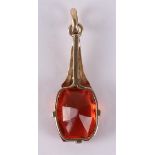 A 14 kt 585/1000 gold Art Deco pendant with a facet cut orange-brown stone.