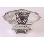 An ajourned second grade 835/1000 silver basket on stand ring with floral decor, 485 grams, circa