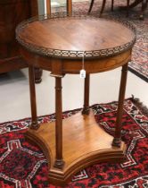 A round mahogany neo-empire table with brass gallery, 19th century. Resting on column legs with