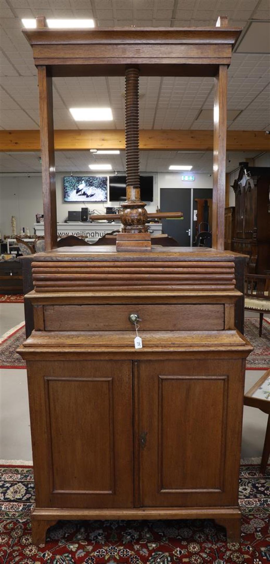 A linen press with drawer, 19th century. Oak, base cabinet with two panel doors, front resting on