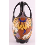 A pottery amphora vase with ears, ca. 1930. Polychrome stylized floral decor, marked: Eskaf Huizen