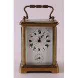 A travel clock in glazed brass casing, France, ca. 1890, h 11 cm.