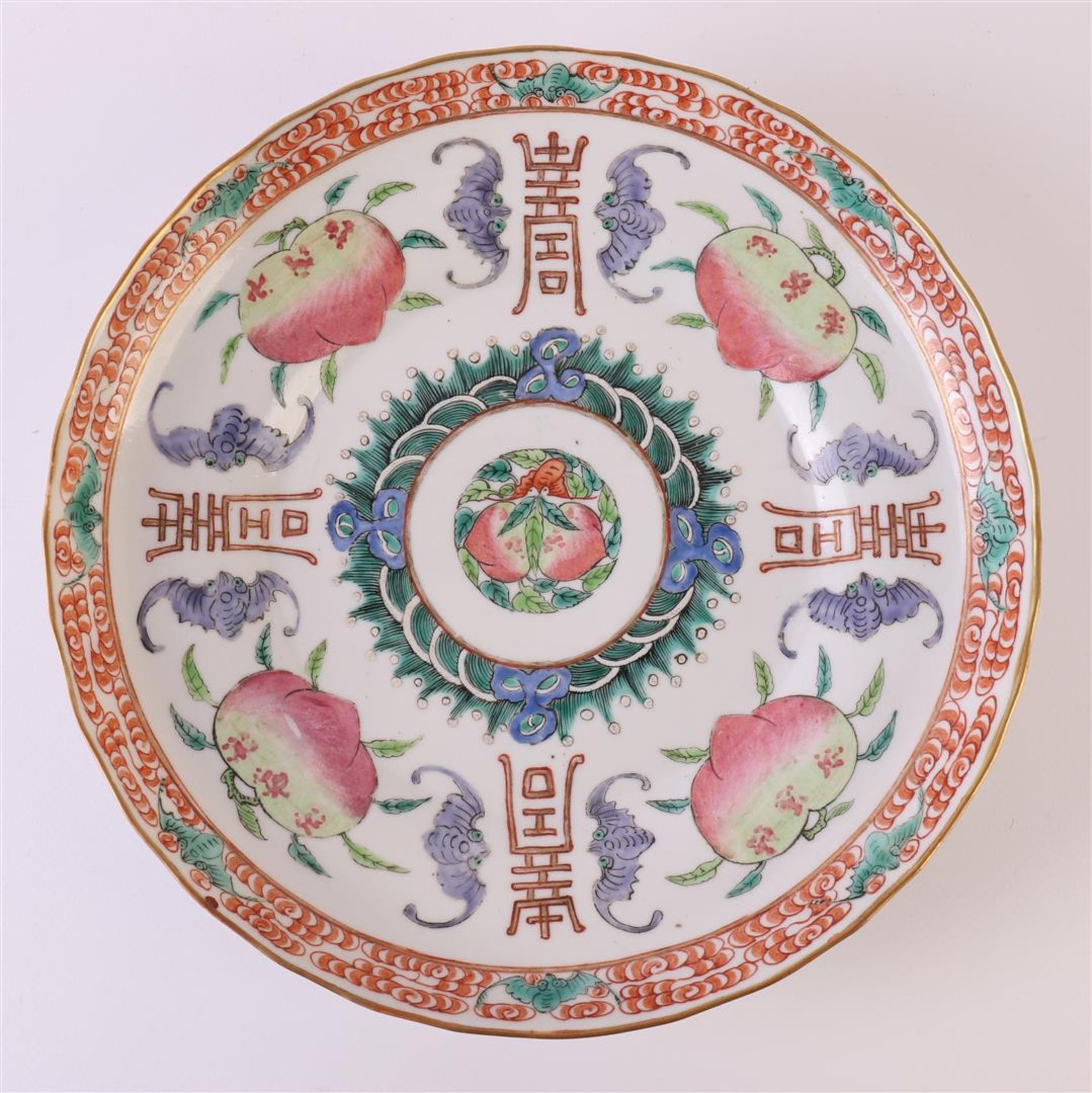 A slightly contoured porcelain dish, Japan, 19th century. Polychrome decor of peaches, bats and - Image 2 of 12