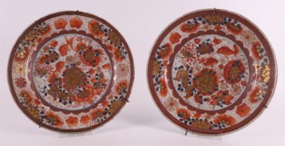A pair of 'rouge de fer' porcelain plates, China, Qianlong 18th century. Polychrome decor of carp