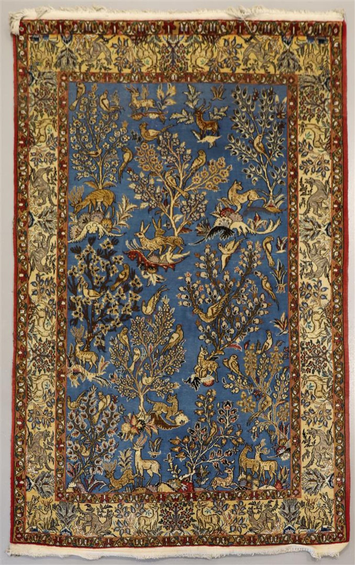 A Persian silk carpet, Ilam Sherkat Farsh. Polychrome decor of deer, hares and birds in floral