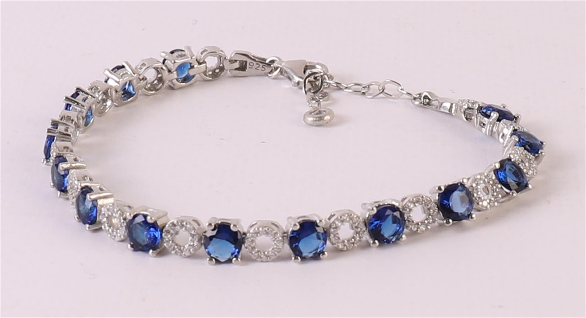 A 1st grade 925/1000 silver tennis bracelet with facet cut blue stones and zirconias. - Image 2 of 3