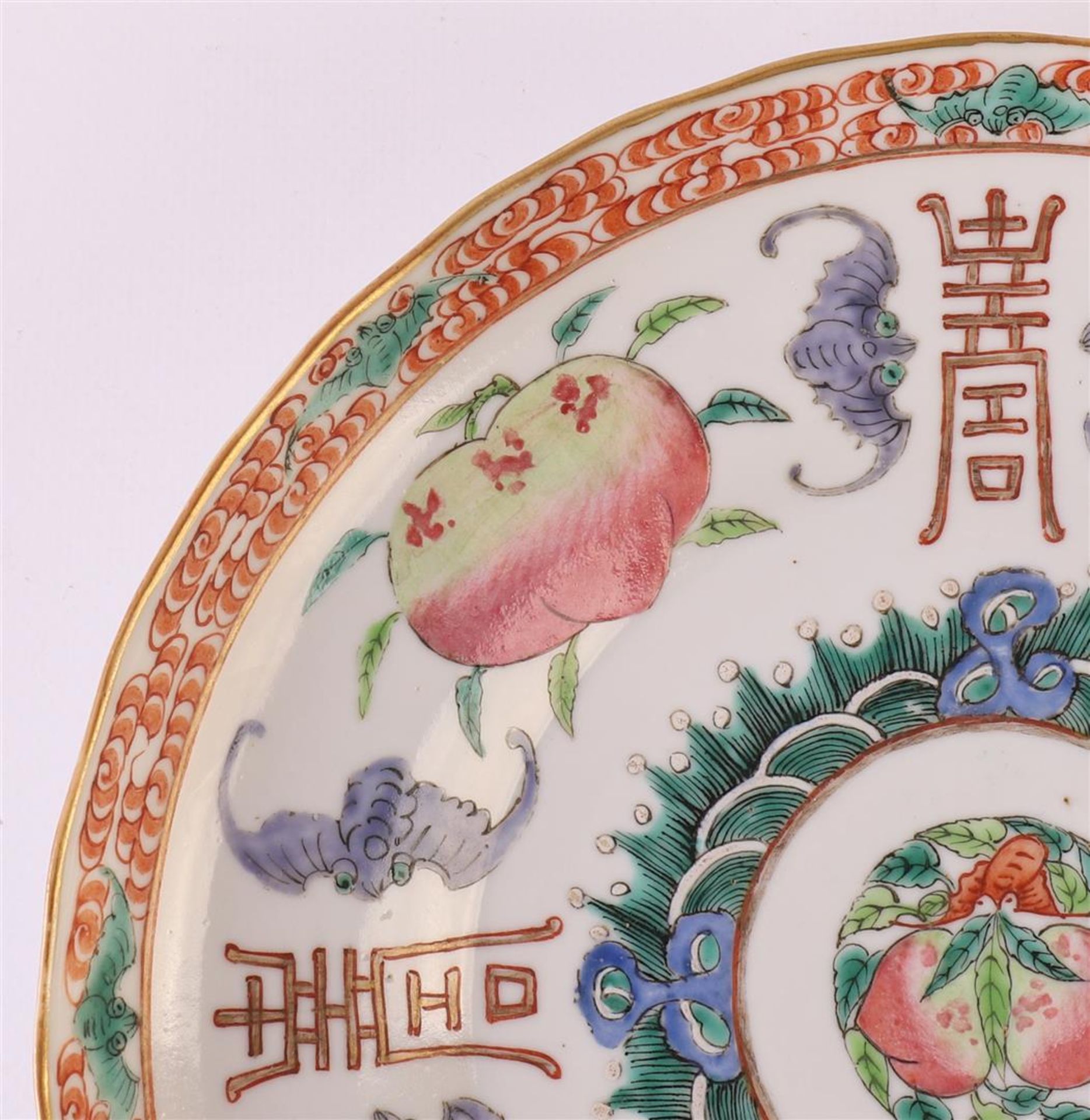 A slightly contoured porcelain dish, Japan, 19th century. Polychrome decor of peaches, bats and - Image 3 of 12