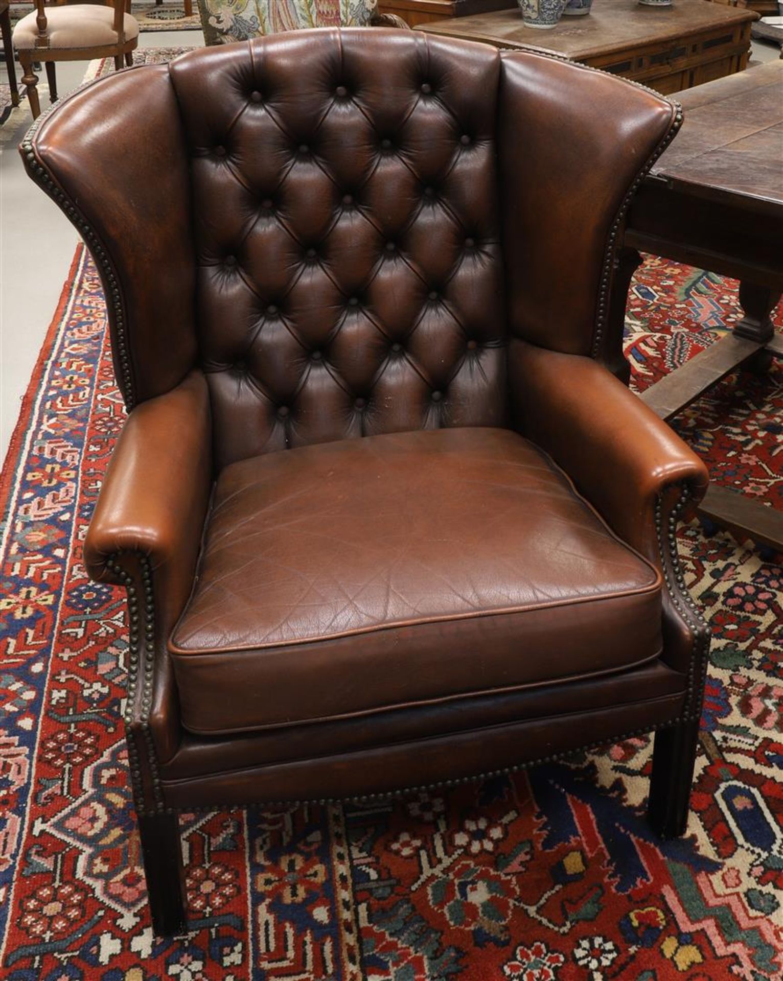 A brown leather ladies' Chesterfield model ear crapaud, padded back frame, 20th century. Seat height