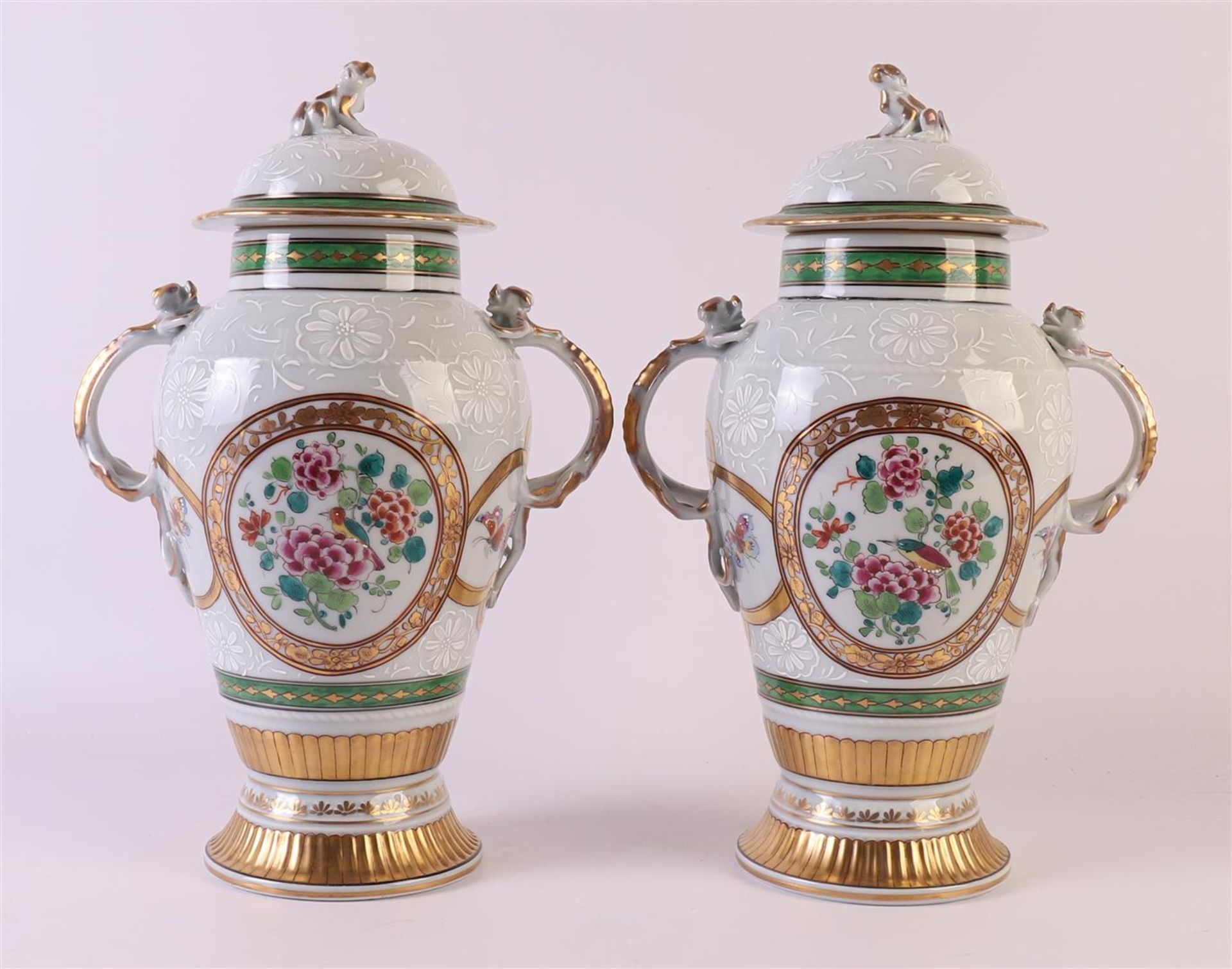 A pair of baluster-shaped porcelain lidded vases with salamanders as ears, France, Samson around