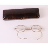 A rectangular tortoiseshell glasses case containing glasses with 14 kt 585/1000 gold frames, late