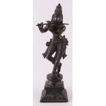 A dark patinated bronze Shiva with flute, India, late 19th century, h 18.5 cm.