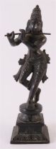 A dark patinated bronze Shiva with flute, India, late 19th century, h 18.5 cm.