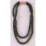 A 2-row necklace of aventurine beads, approximately 10mm thick with a 14 carat 585/1000 gold hook