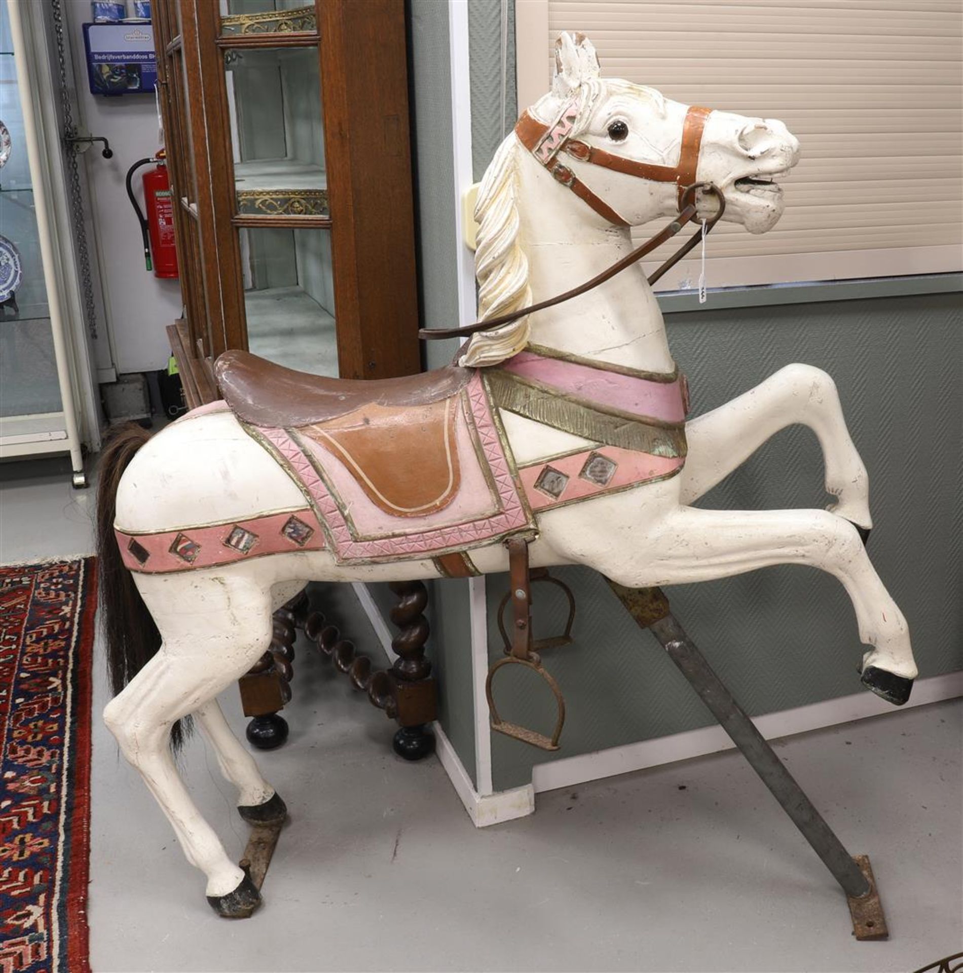 A white lacquered wooden fair horse, mid-20th century, h 140 x l 130 cm.