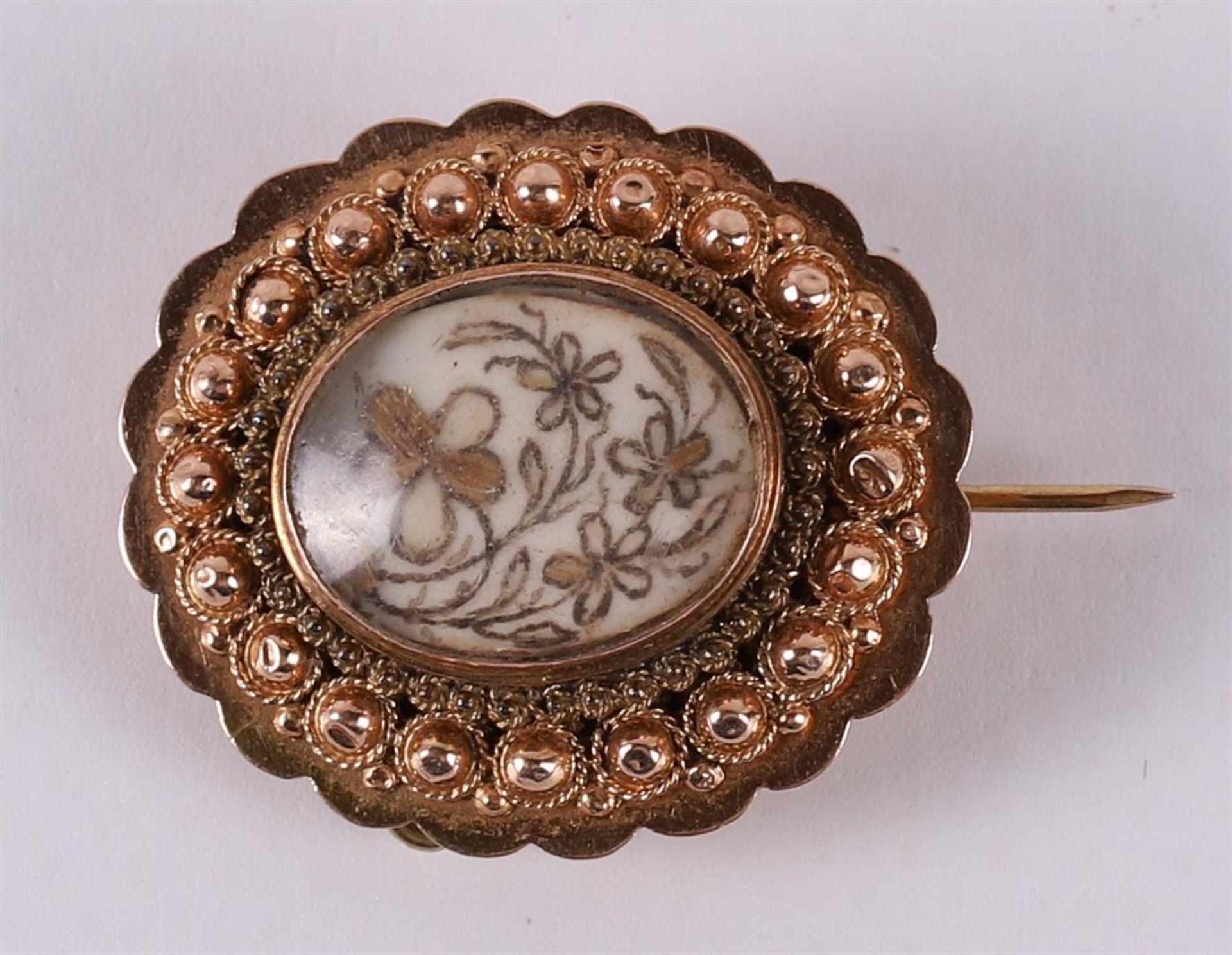A 14 kt 585/1000 gold brooch with hairpiece, 19th century.