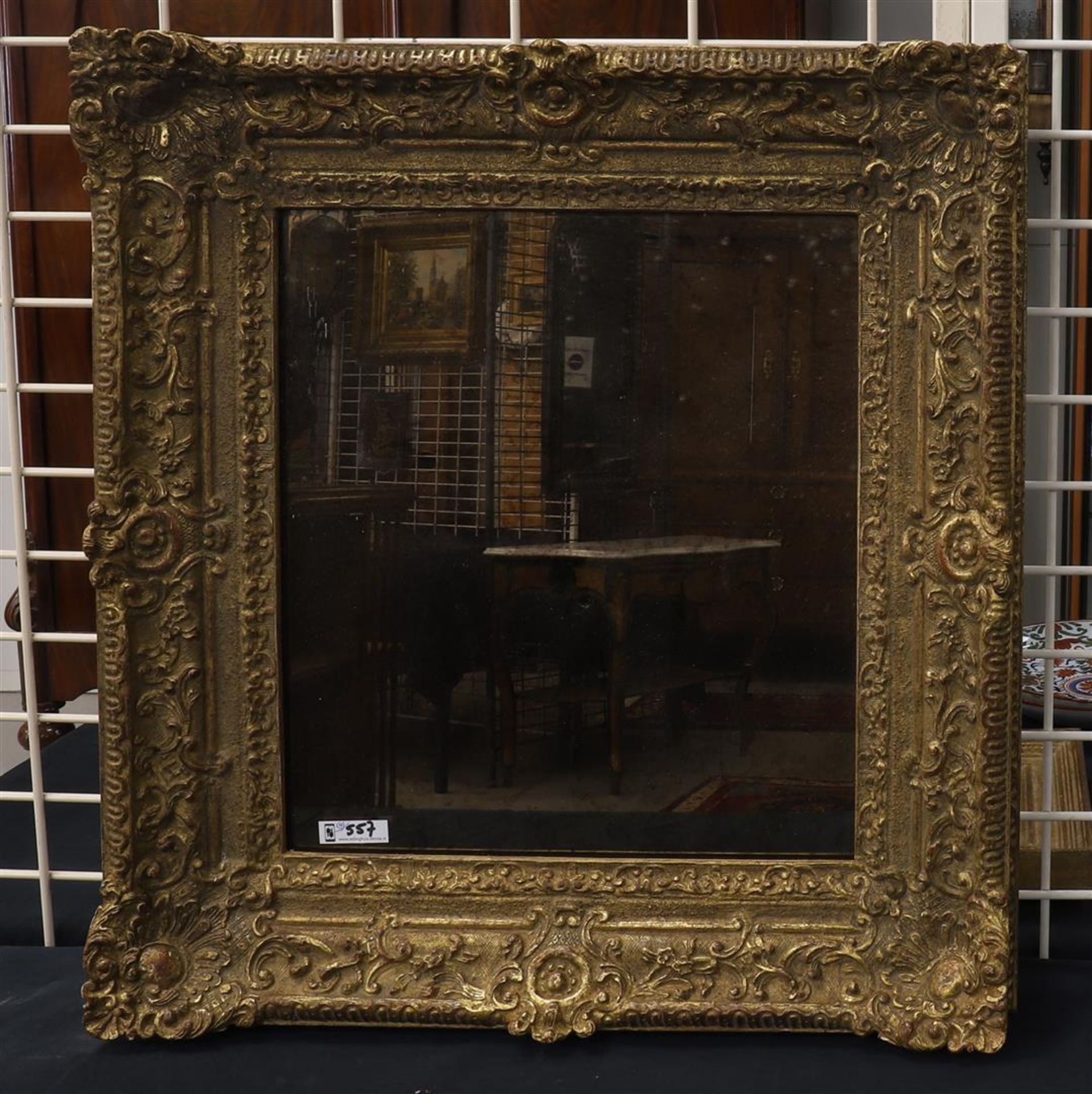 A rectangular mirror in ornamental frame, Holland, 1st half of the 20th century, h 50 x w 53 cm.