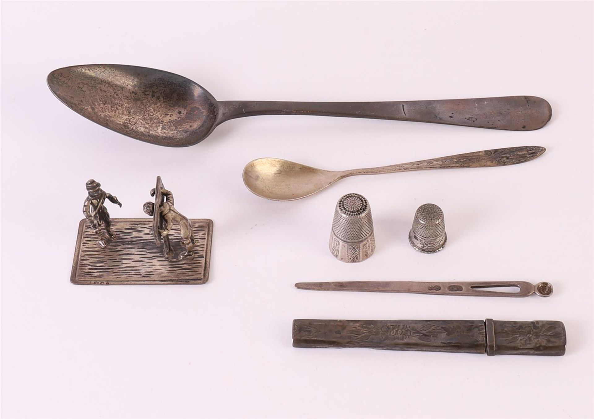 A lot of various silver, including a miniature of a man on a scaffold, needle case and spoon,