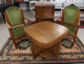 An Amsterdam school dining table and associated salon chairs, ca. 1920. Oak, blackened wooden