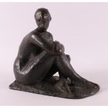 A brown patinated bronze sculpture of a seated female nude, 1918-1993.