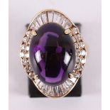 A 14 kt gold ring with a cabochon cut amethyst.