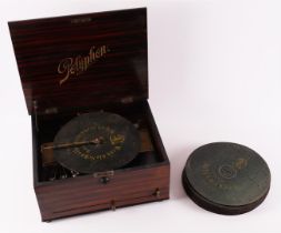 A polyphonic record music box with three bells and various records, 19th century