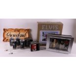 A lot of various Elvis Presley memorabilia, including glasses and television, po