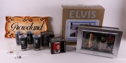 A lot of various Elvis Presley memorabilia, including glasses and television, po