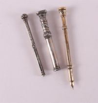 Three various silver sliding pencil holders, including gold-plated and with text