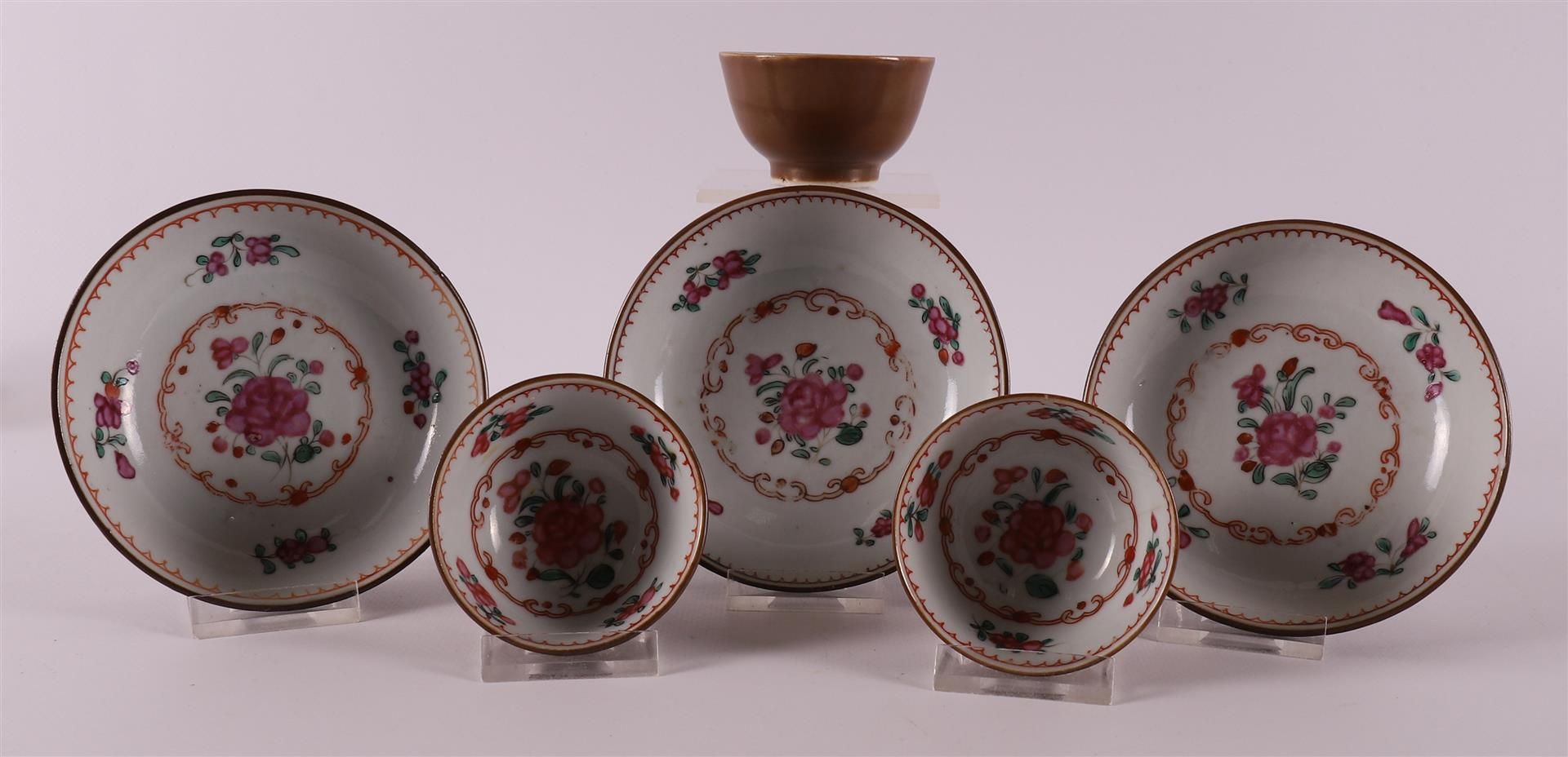 Three famille rose cups and saucers on capucine ground, China, Qianlong, 18th ce