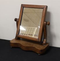 A mahogany mirror with ebonised columns as posts, ca. 1830.