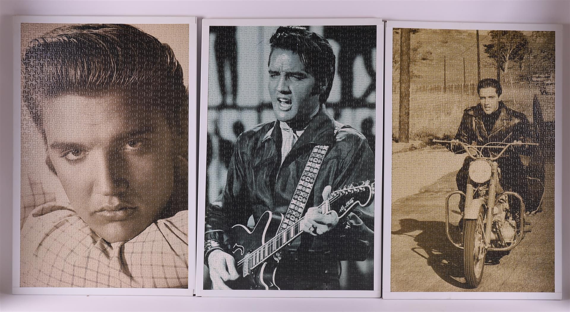 A lot of various Elvis Presley memorablia, posters and puzzles as posters.