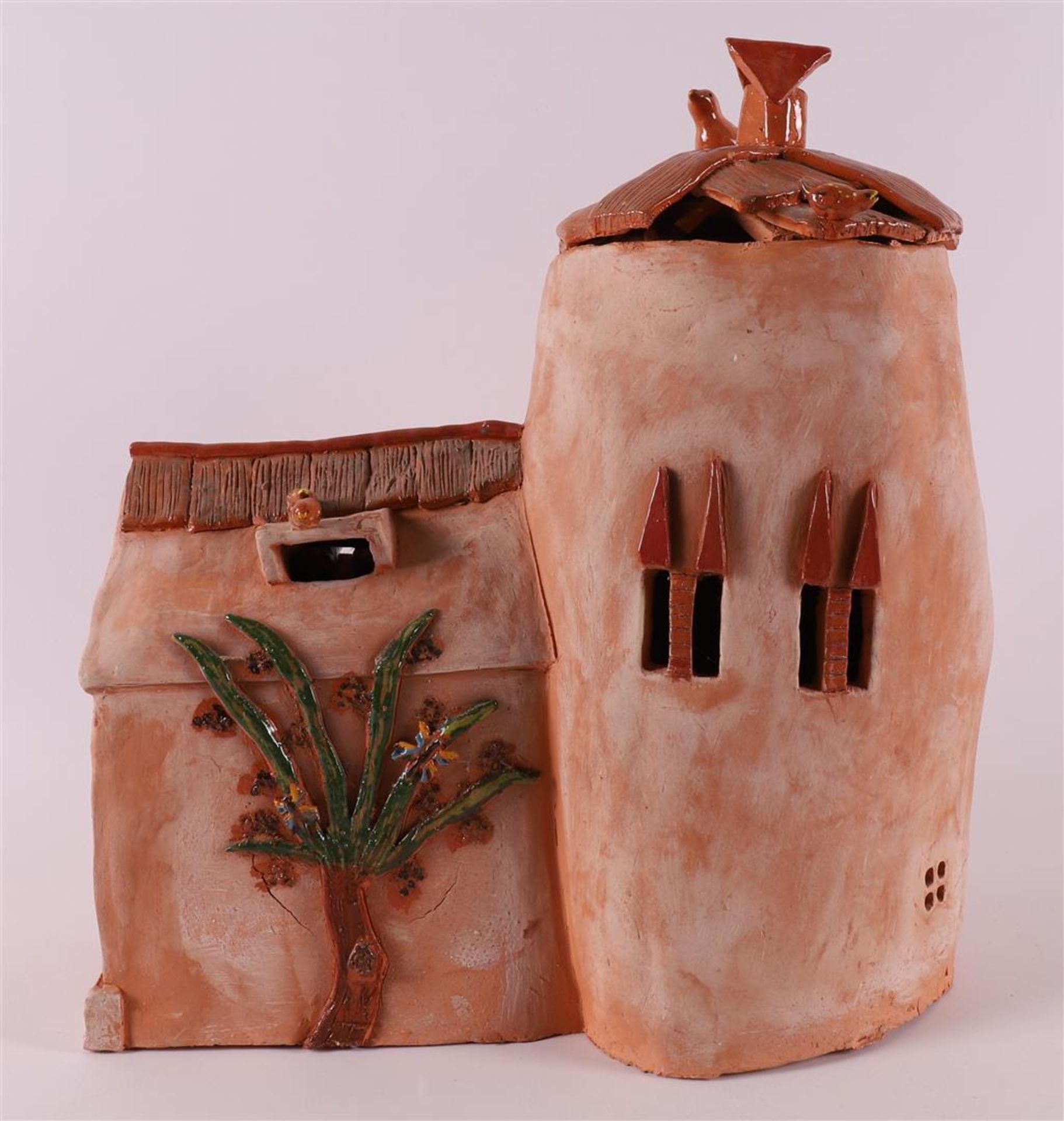 A ceramic sculpture of a house with a loose roof, modern/contemporary.