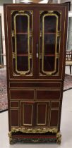 A red lacquer/ebonised and gilded two-door display cabinet, China, 20th century