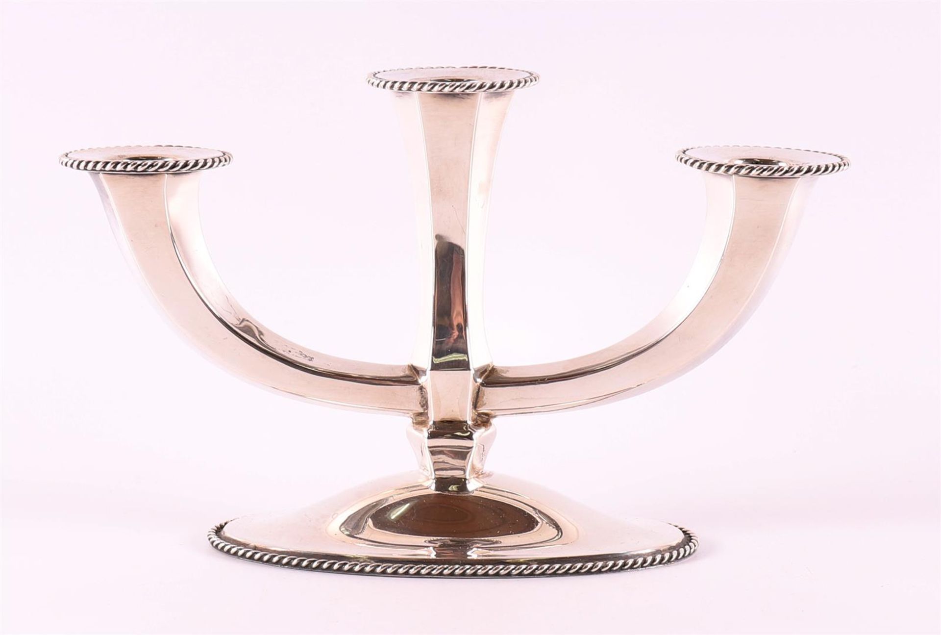 A second grade 835/1000 silver 3-light candlestick, 20th century.