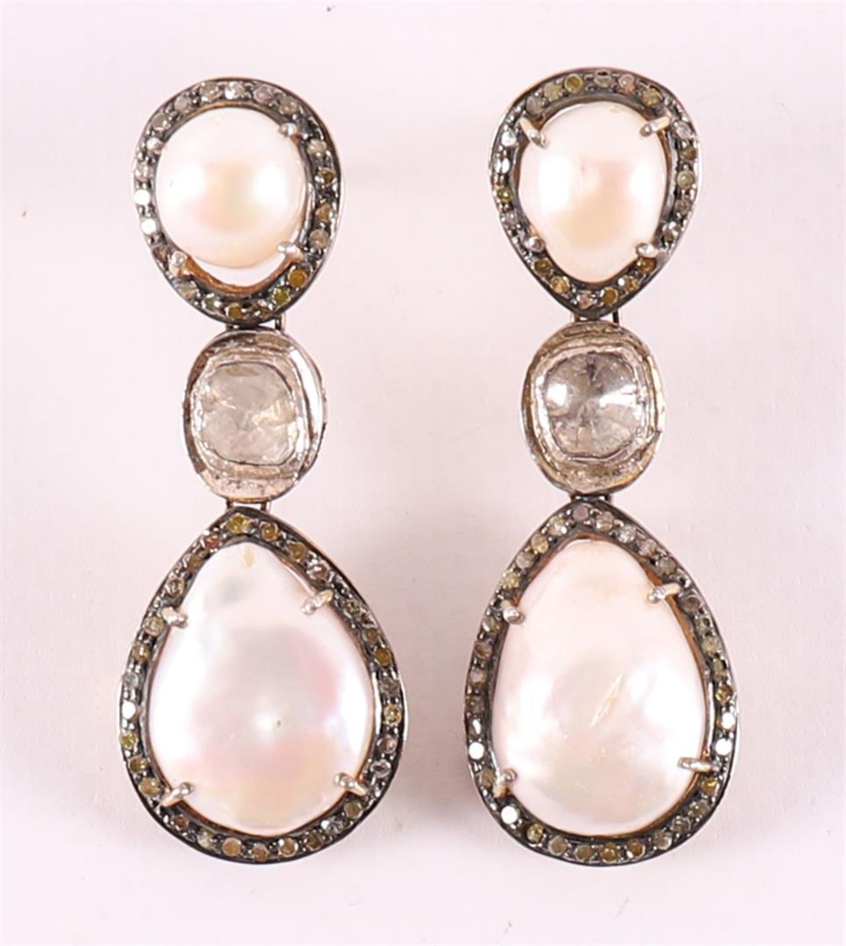 A pair of partly gold-plated silver earrings with 4 pearls, surrounded by diamon