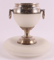 An opaline glass cigar cup with silver frame and rings as handles.
