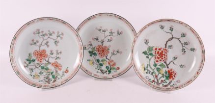 A series of three porcelain famille verte deep dishes, China, 18th century.