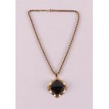 A 14 kt yellow gold necklace on a ditto gold square pendant, set with garnet.