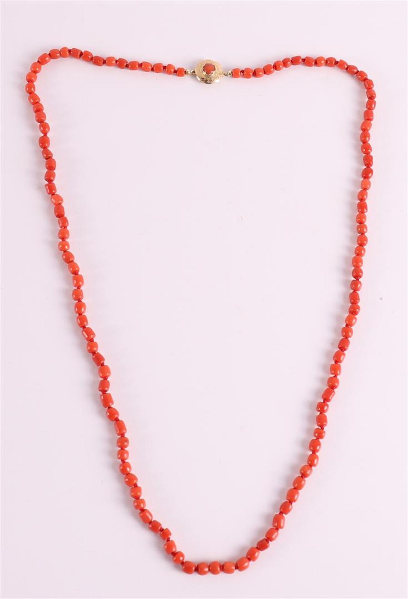 A three-row necklace of red corals on a 14 carat gold clasp, around 1900.