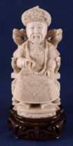 A carved ivory seated emperor, China, Guangxu (1875-1908), ca. 1910