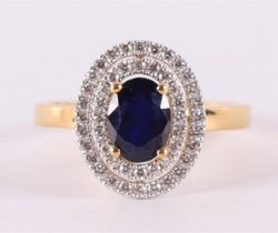 A 9 kt BWG ring with facet cut blue sapphire, flanked by zirconias