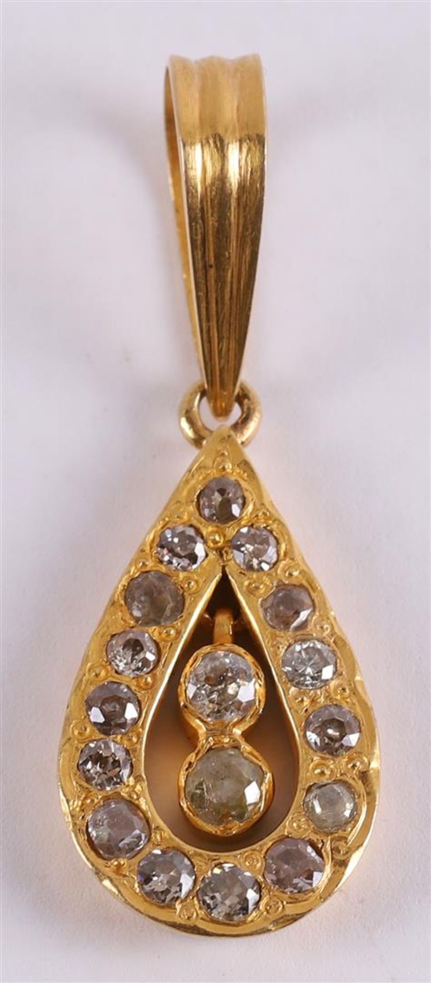A 14 kt yellow gold drop-shaped pendant, set with 17 brilliant cut diamonds.