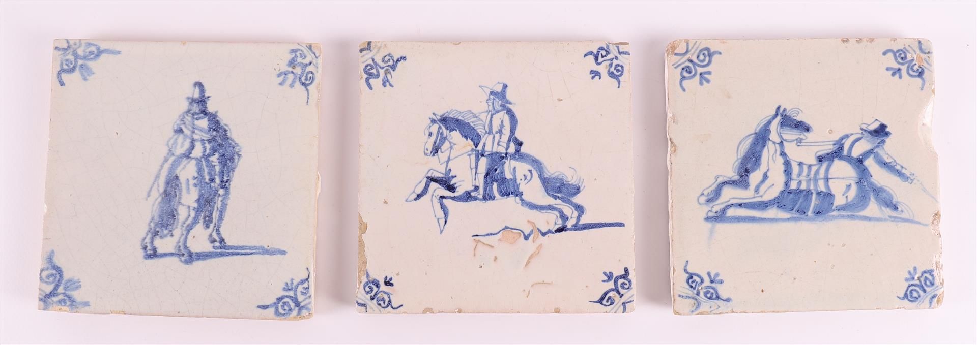 Three blue/white equestrian tiles with ox head corner motifs, Holland 17th centu