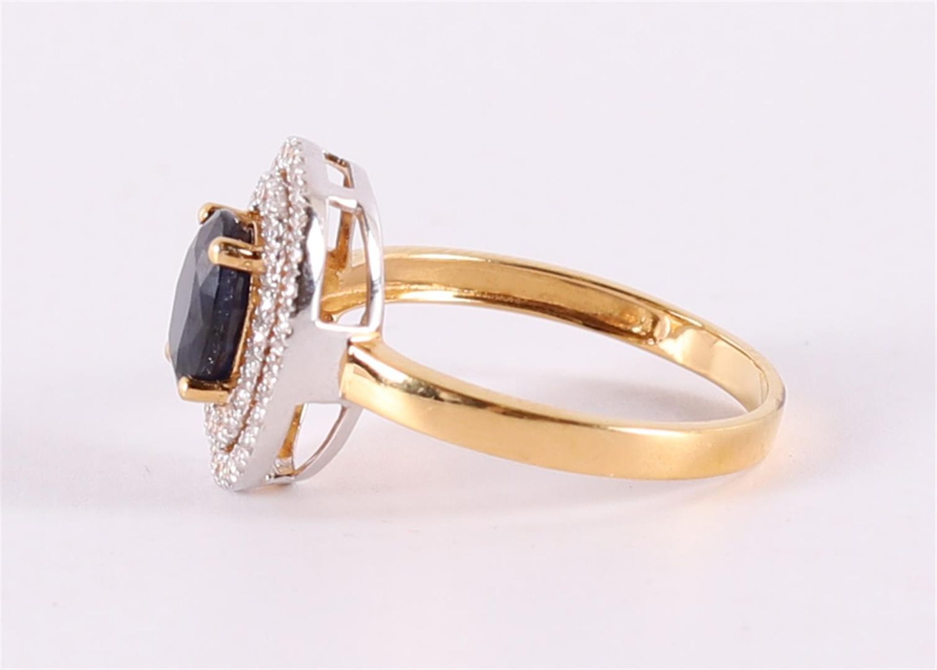 A 9 kt BWG ring with facet cut blue sapphire, flanked by zirconias - Image 2 of 2